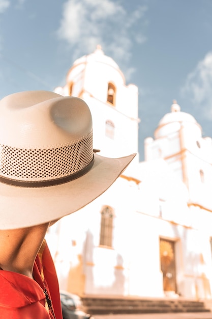 Jeune homme nicaraguayen avec chapeau regardant vers l'église cathédrale au Nicaragua