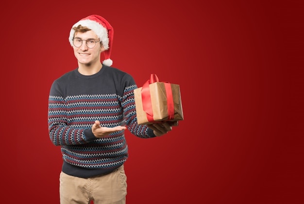 Jeune homme à Noël fait des gestes