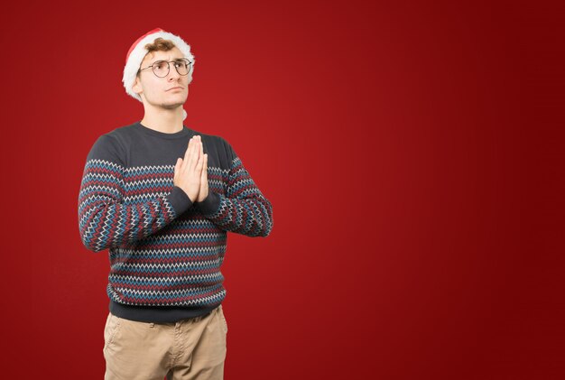Jeune homme à Noël fait des gestes