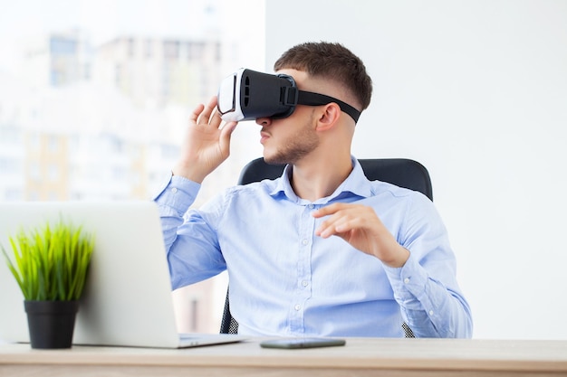 Photo jeune homme portant des lunettes de réalité virtuelle dans un studio de coworking moderne