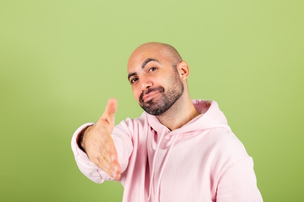 Photo jeune homme de race blanche chauve en sweat à capuche rose