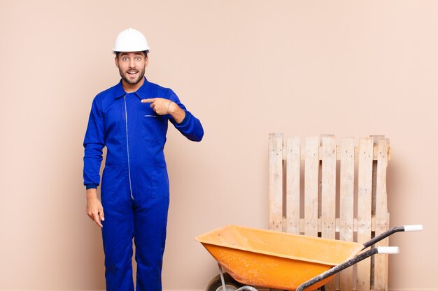 Jeune homme à la recherche de plaisir, fier et surpris, pointant joyeusement vers soi, se sentant confiant et concept de construction élevé