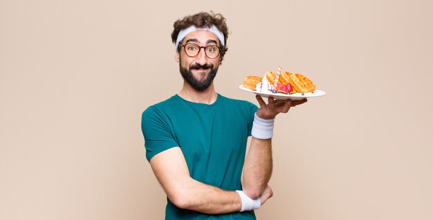 Jeune homme sportif avec des gaufres. concept de régime