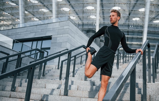 Jeune homme en tenue sportive s'entraîne à l'extérieur pendant la journée