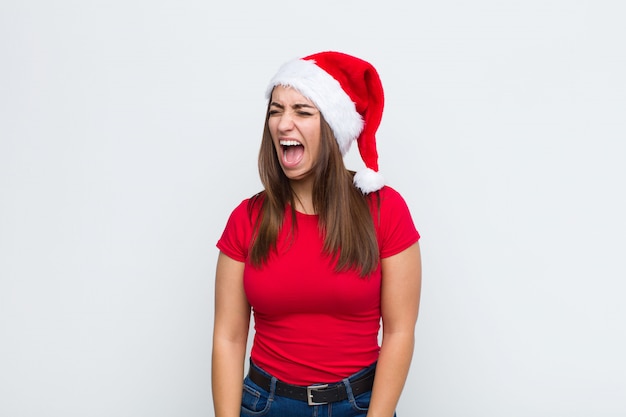 Jeune jolie femme avec Bonnet de Noel. Concept de Noël