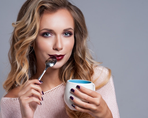 Jeune jolie femme buvant du café