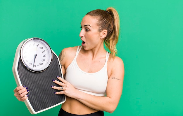 Jeune jolie femme avec un concept de régime et de remise en forme à l'échelle