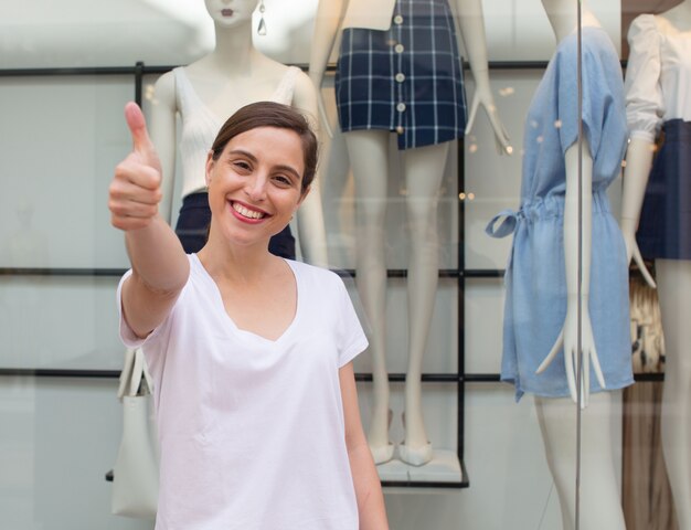 jeune jolie femme heureuse et satisfaite shopping chothes dans un centre commercial