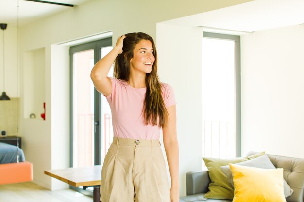 Jeune jolie femme souriant joyeusement et avec désinvolture