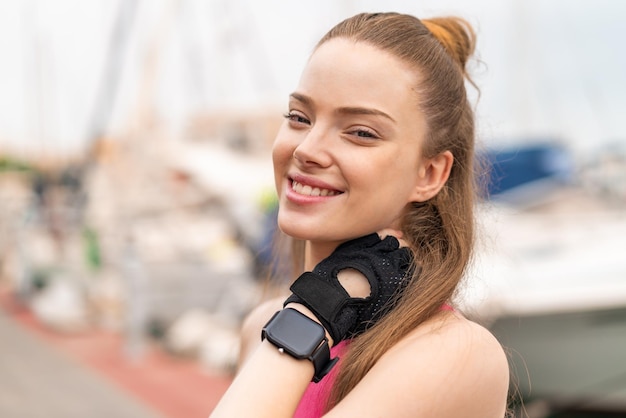 Jeune jolie fille sportive à l'extérieur avec une expression heureuse