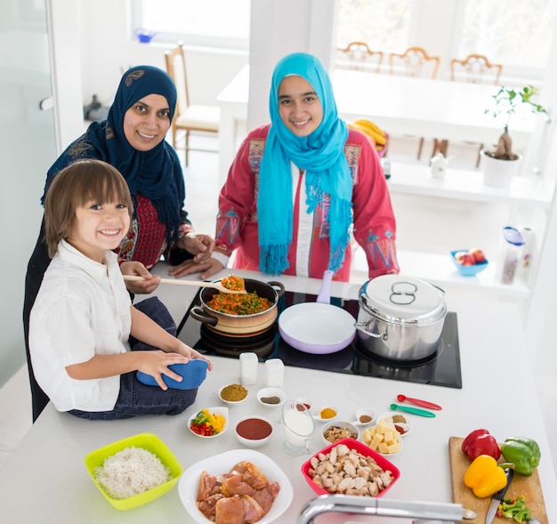 Jeune maman arabe avec un fils mignon dans la cuisine faisant de la nourriture pour l&#39;iftar au Ramadan