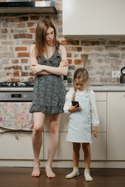 Jeune maman avec sa jolie fille dans la cuisine