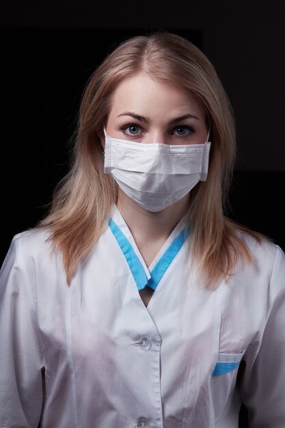 Jeune médecin blonde avec un masque protecteur