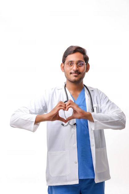 Jeune médecin indien en forme de coeur avec la main sur fond blanc.