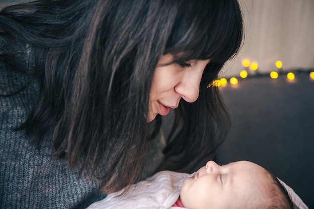 Une jeune mère avec une petite fille nouveau-née dans ses bras