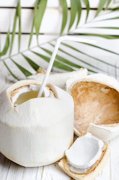 Jeune noix de coco sur une table en bois blanc