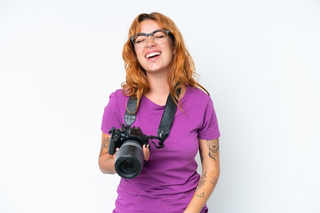 Jeune photographe caucasien femme isolée sur fond blanc en riant