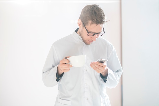 Un jeune travailleur médical masculin, médecin en uniforme blanc, médecin confiant