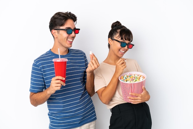 Jeunes amis métis isolés sur fond blanc avec des lunettes 3d et tenant un grand seau de pop-corn