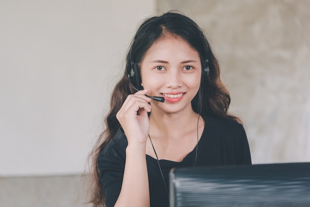 Photo jeunes employés de l'opérateur travaillant avec un casque avec contact sur cal