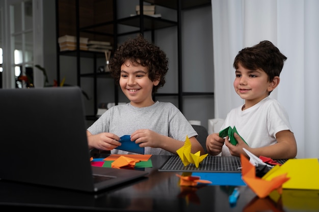 Jeunes enfants jouant avec du papier origami