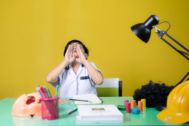 Les jeunes étudiants font des gestes amusants Matériel d'apprentissage sur la table