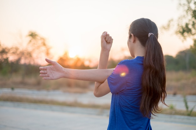 Jeunes femmes font de l&#39;exercice avant de faire de l&#39;exercice au parc