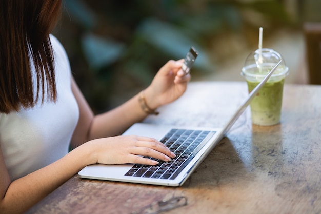 Jeunes femmes utilisant un ordinateur portable et une carte de crédit, shopping en ligne, concept de commerce électronique