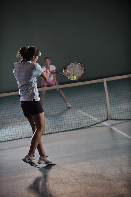 jeunes filles jouant au tennis à l'intérieur