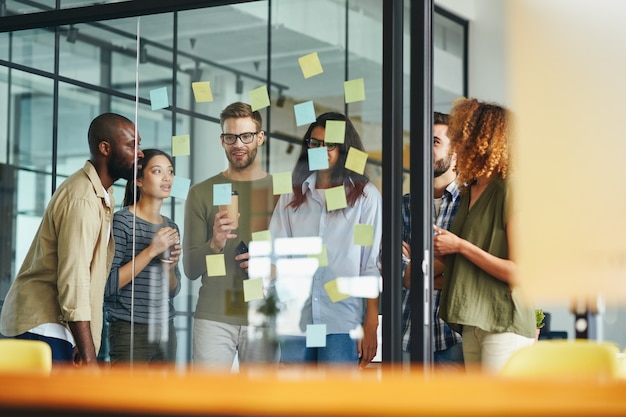 Jeunes hommes et femmes inventifs ayant une discussion productive