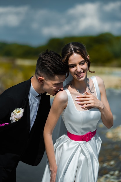 Jeunes mariés marchant en plein air le jour du mariage