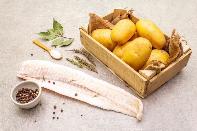 Jeunes pommes de terre crues et filets de merlu surgelés aux herbes et épices