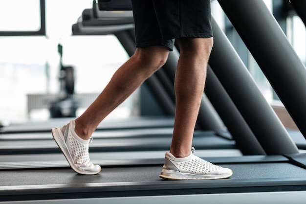 Jogging Workout Cropped Shot Of Black Male Training On Treadmil At Gym