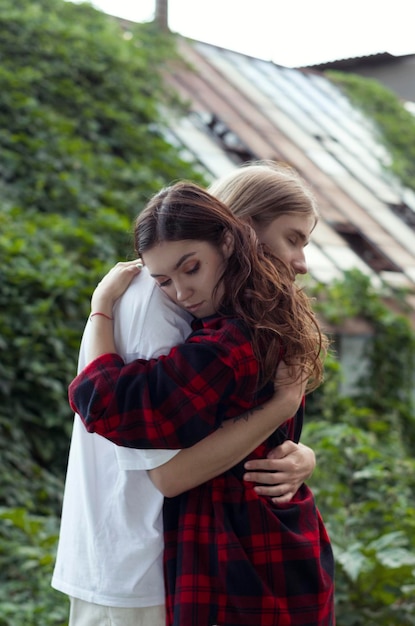 Joli couple d'adolescents sur fond de verdure dans le parc fille et garçon s'embrassent