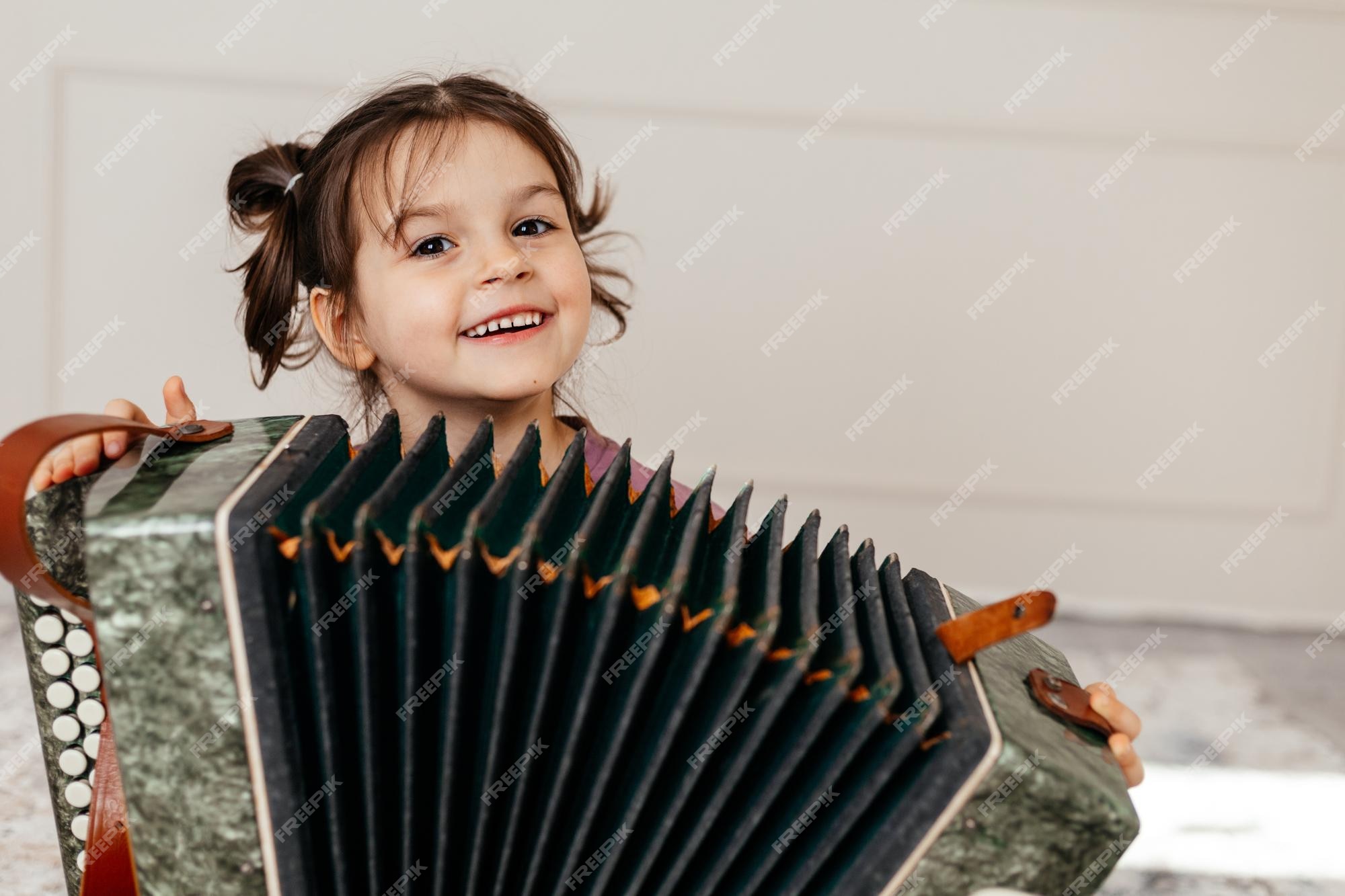 Joli Enfant Jouant D'un Instrument De Musique Appelé Harmonica Ou Accordéon