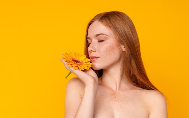 Jolie femelle rousse avec fleur lumineuse