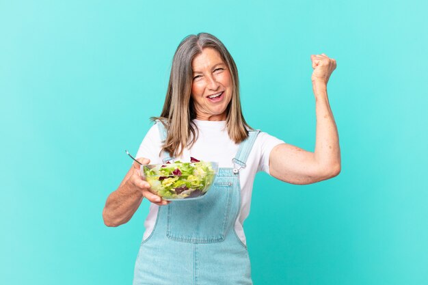 Jolie femme d'âge moyen ayant une salade.