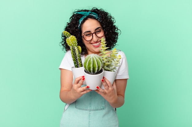 Jolie femme arabe avec cactus en pot décoratif