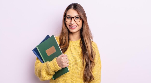 Jolie femme asiatique semblant heureuse et agréablement surprise. concept d'étudiant