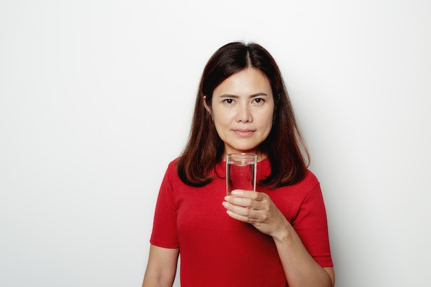 Jolie femme buvant de l'eau en verre