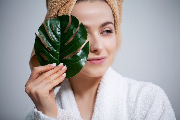 Jolie femme dans la salle de bain faisant une procédure cosmétique pour les soins de la peau du visage