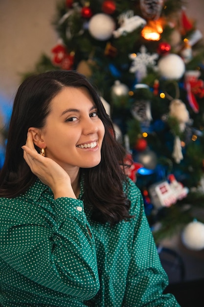 Jolie femme décorant le sapin de noël à la maison