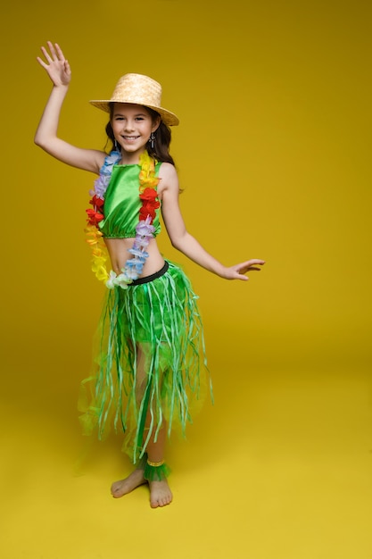 Jolie fille en costume hawaïen et chapeau.