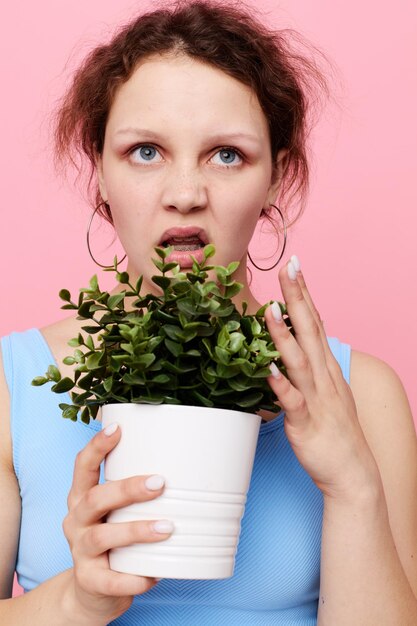 Jolie fille fleur en pot blanc posant émotion vue recadrée inchangée