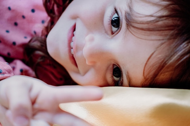 Jolie fille rousse avec de beaux yeux montre un bon comportement à la maison