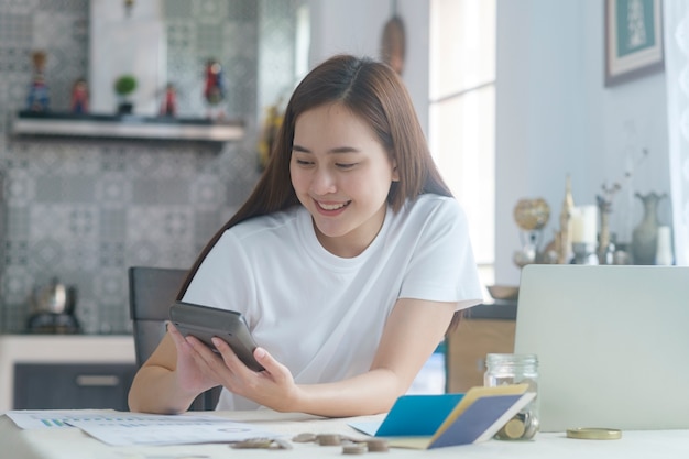 Jolie jeune femme asiatique travaillant à la maison.