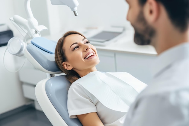 Une jolie jeune femme assise dans un fauteuil dentaire dans un centre médical pendant qu'un médecin professionnel lui répare les dents