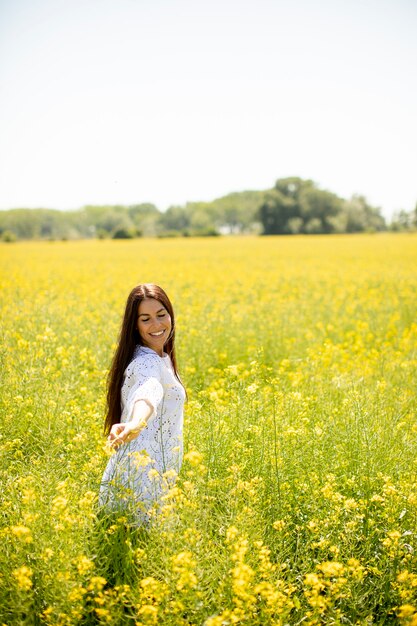 Jolie jeune femme dans le champ de colza