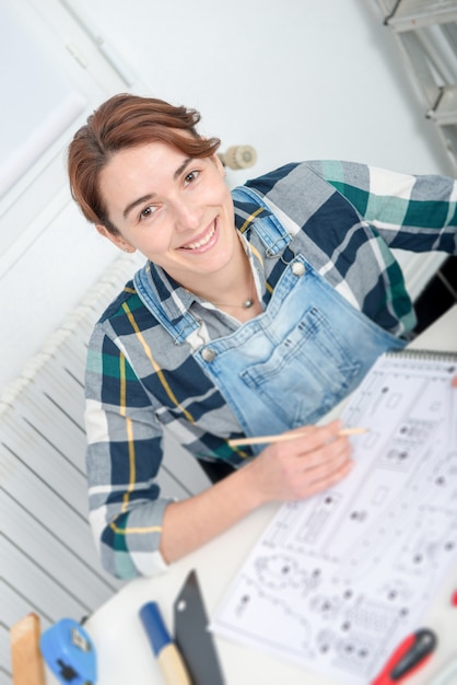 Jolie jeune femme fait du bricolage à la maison