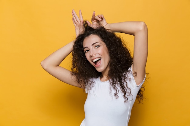 Photo jolie jeune femme posant isolée sur jaune.